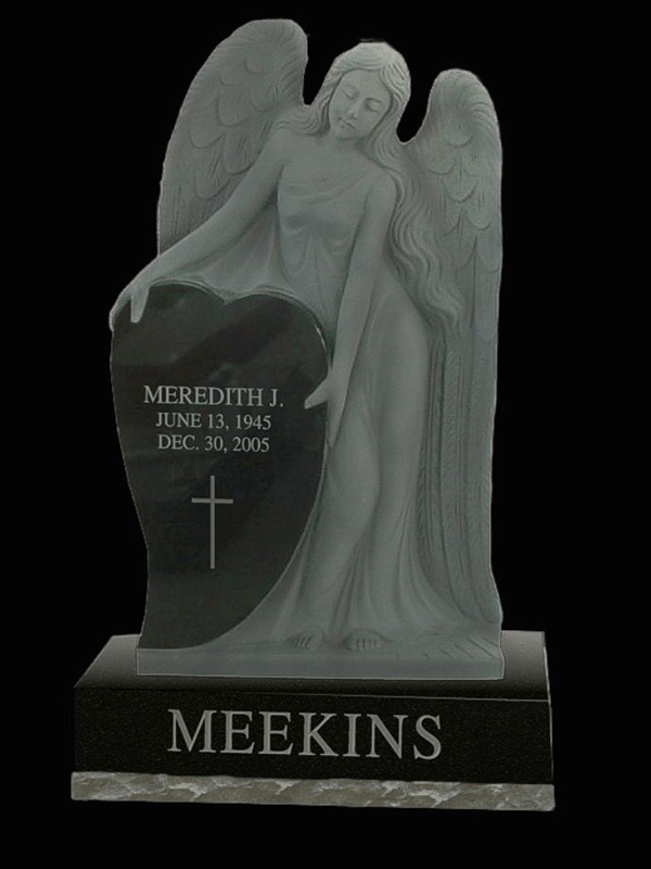 Monument-Meekins custom monument with black granite and angel statue.